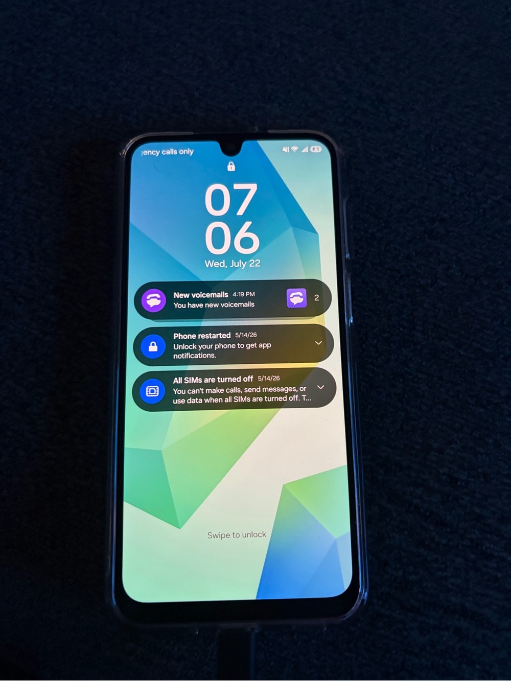 Samsung Smartphone in Black with Blue-Green Wallpaper